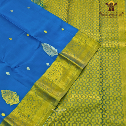 Vibrant royal blue with a rich gold zari border featuring a subtle green undertone Saree
