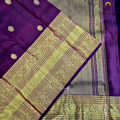 A rich wine maroon body with elegant gold zari butta Saree