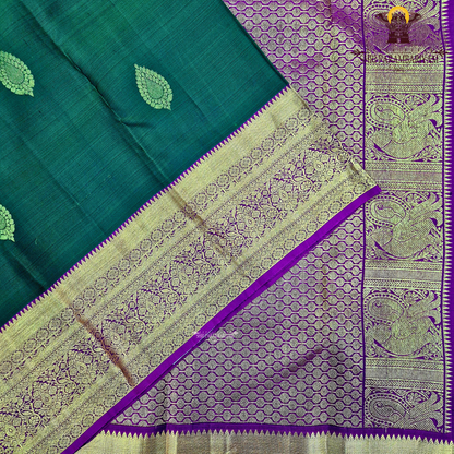 A rich bottle green with a gold zari border and a contrasting magenta (rani pink) edging Saree