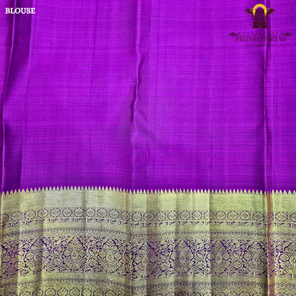 A rich bottle green with a gold zari border and a contrasting magenta (rani pink) edging Saree