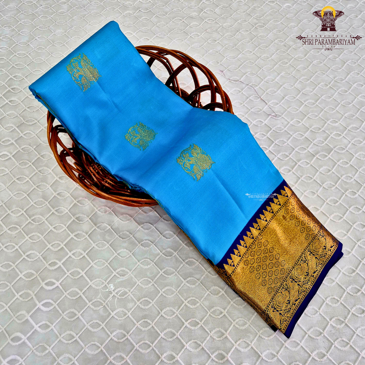 A vibrant sky blue body adorned with elegant gold zari Saree
