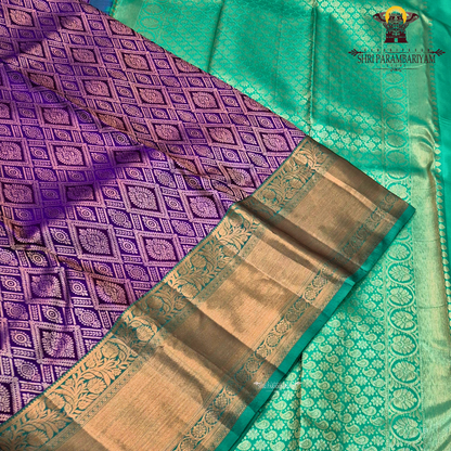 A rich royal purple body, paired with a contrasting emerald green korvai border Saree