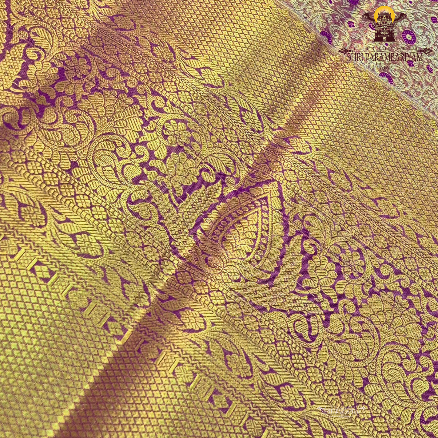 Rich antique gold with deep magenta / purple accents Saree