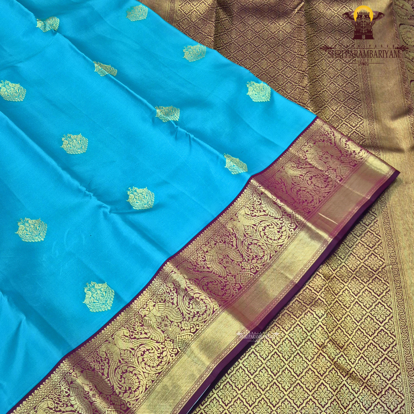 A Vibrant turquoise blue (peacock blue) body beautifully highlighted Saree