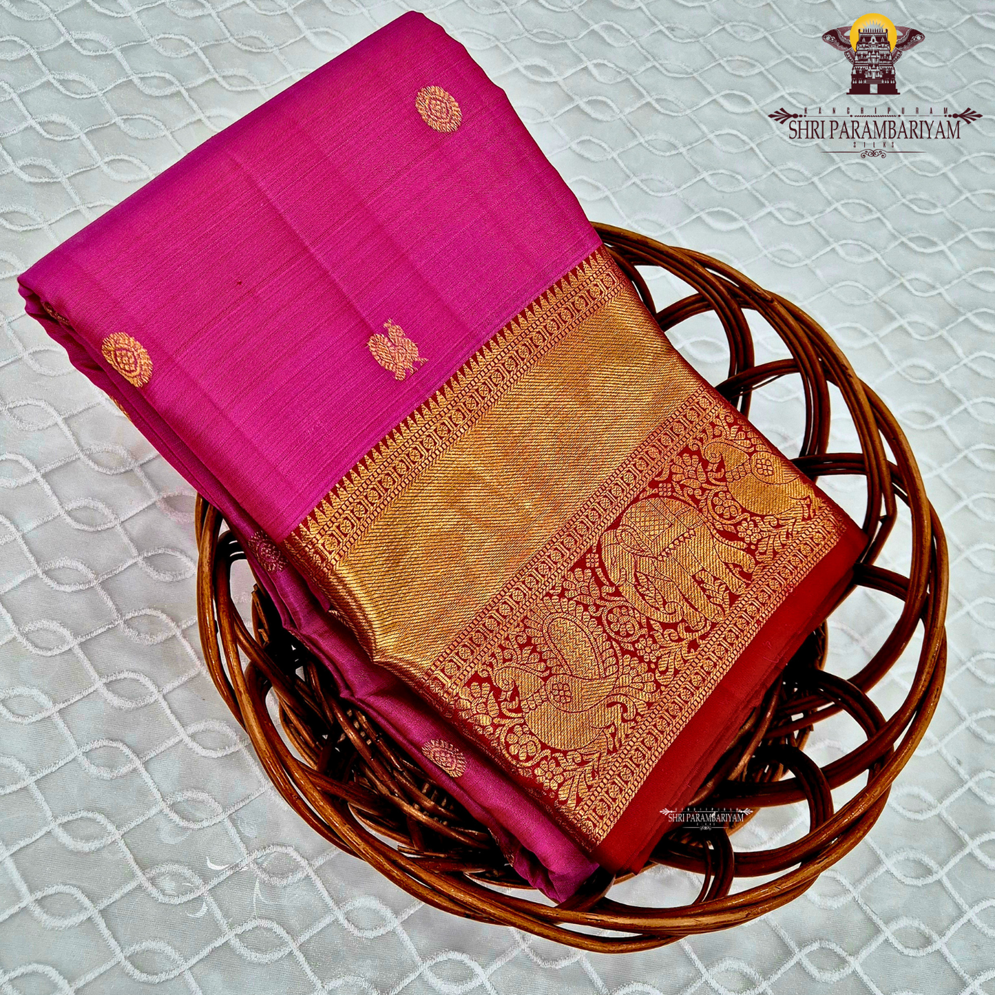 A bright rani pink with a rich red border Saree