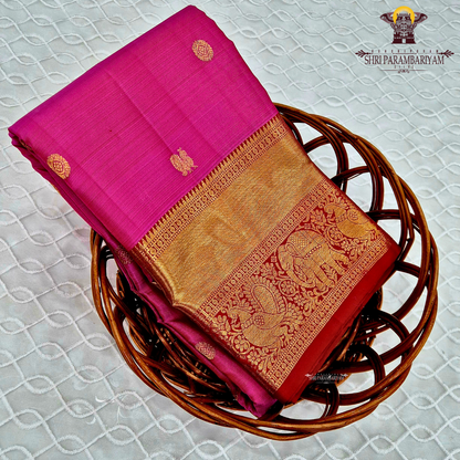 A bright rani pink with a rich red border Saree