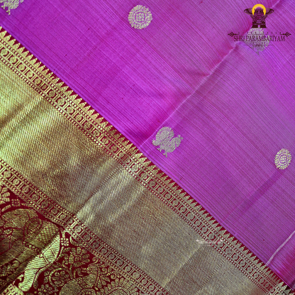 A bright rani pink with a rich red border Saree