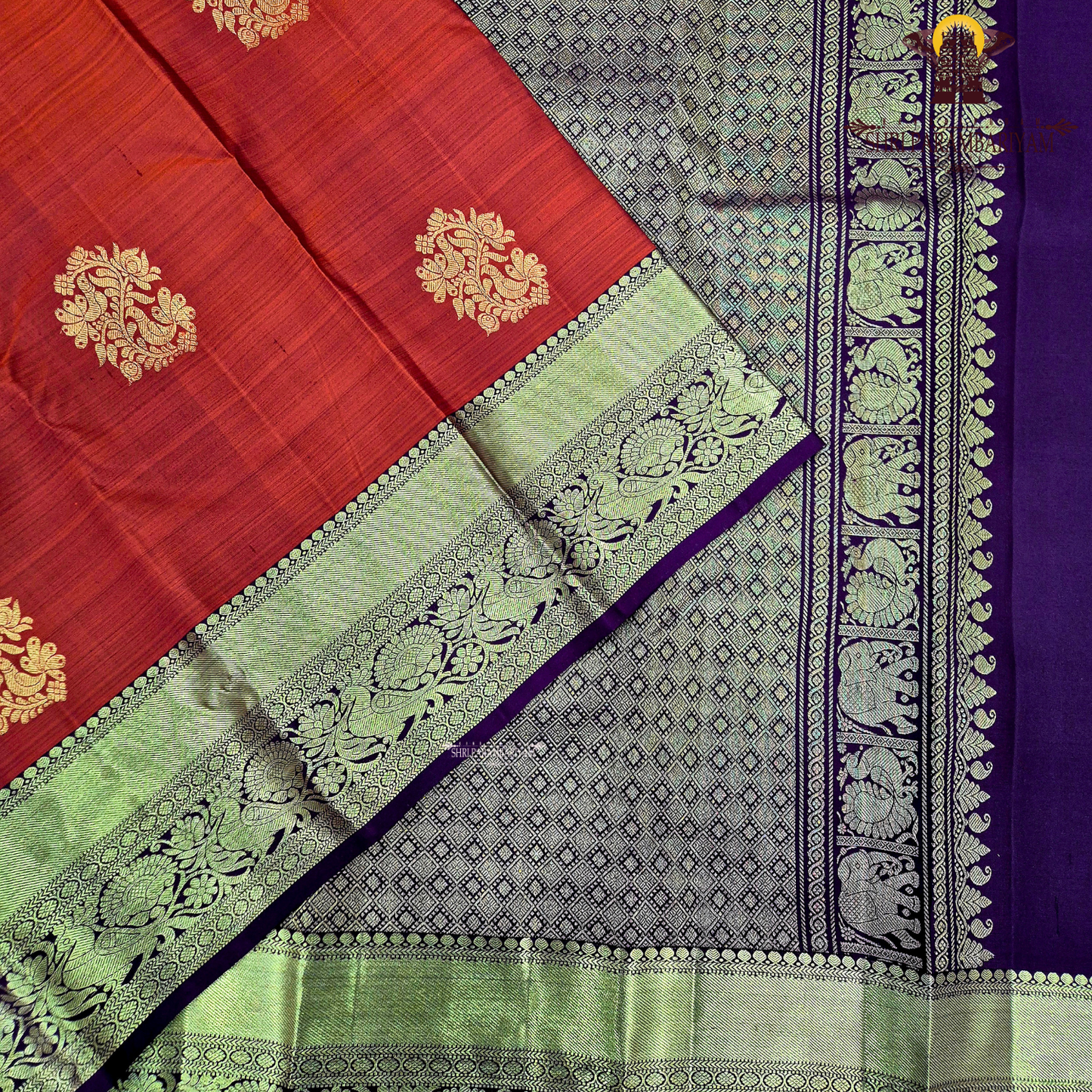A vibrant brick red body with a rich gold zari border and pallu Saree
