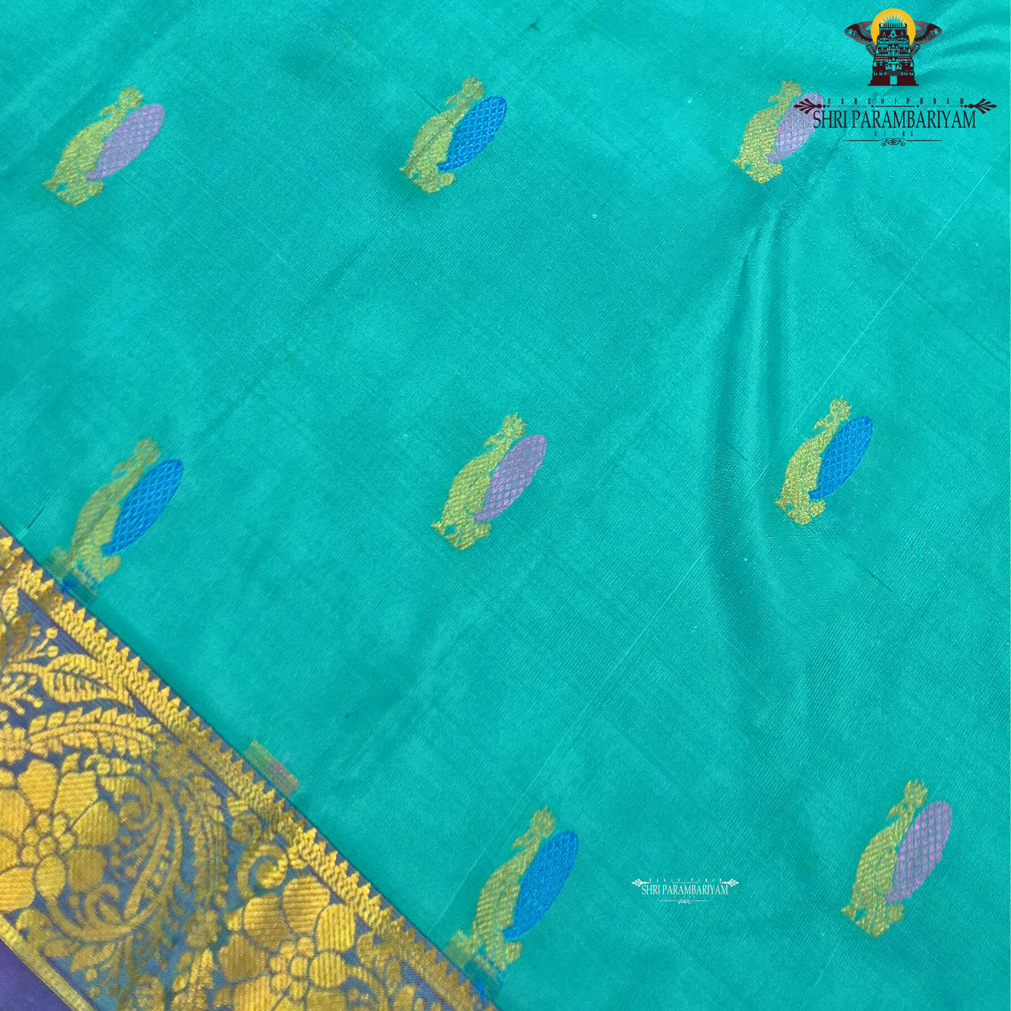 A vibrant turquoise blue / sea green body paired with a rich purple 2-inch border Saree