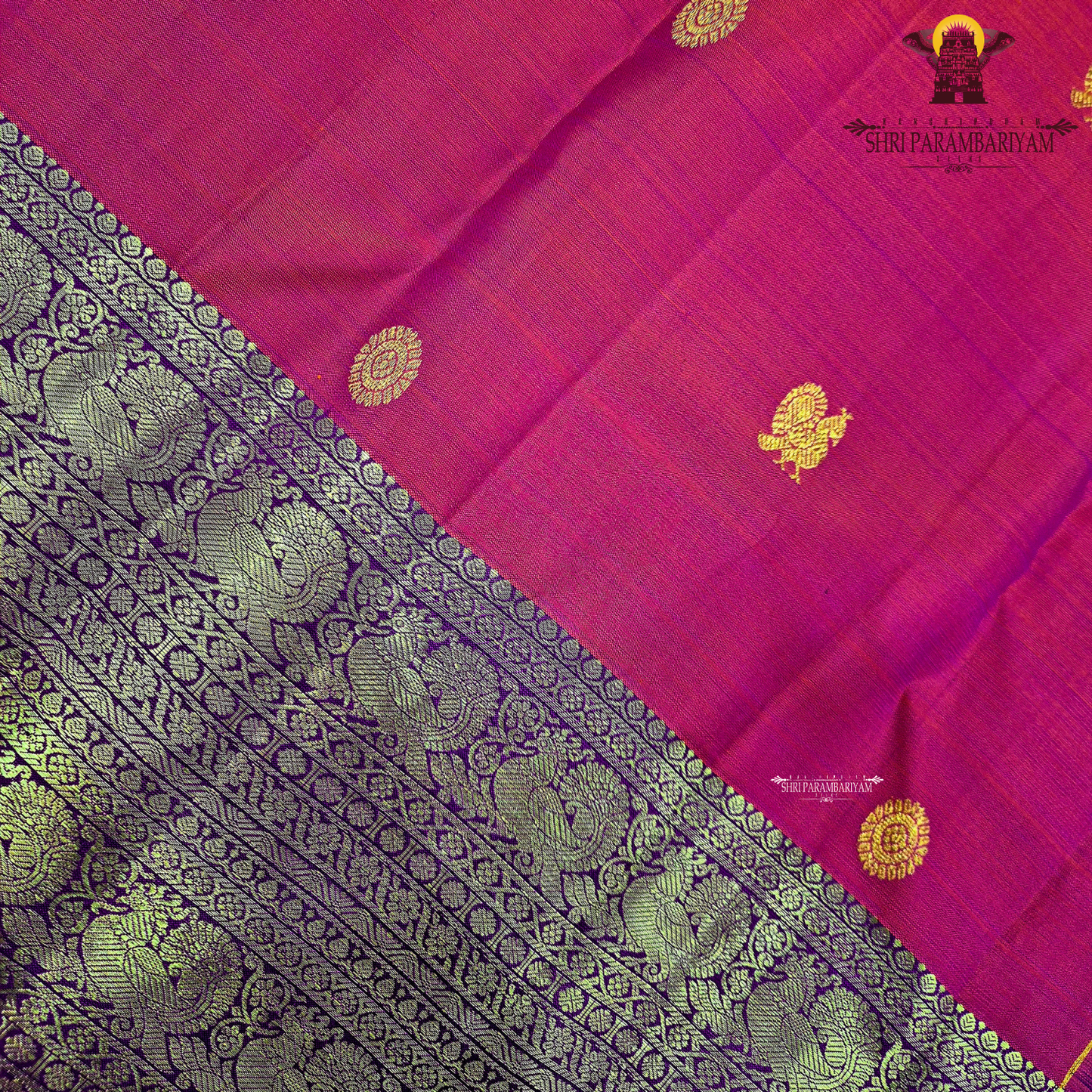 A bright vermilion red with a rich violet/purple border Saree