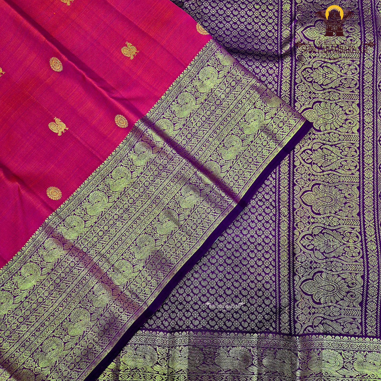 A bright vermilion red with a rich violet/purple border Saree