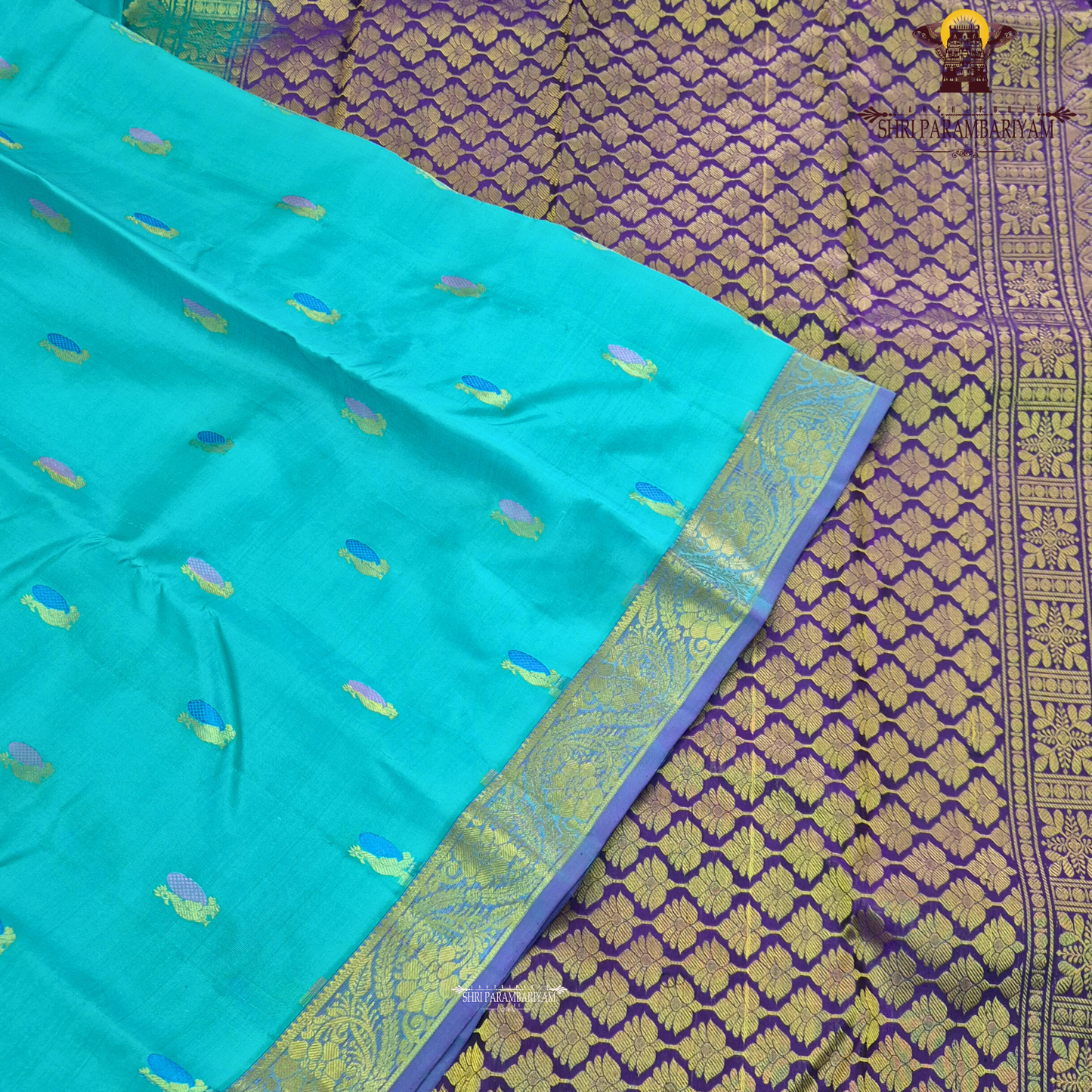 A vibrant turquoise blue / sea green body paired with a rich purple 2-inch border Saree
