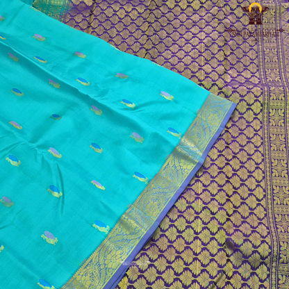 A vibrant turquoise blue / sea green body paired with a rich purple 2-inch border Saree