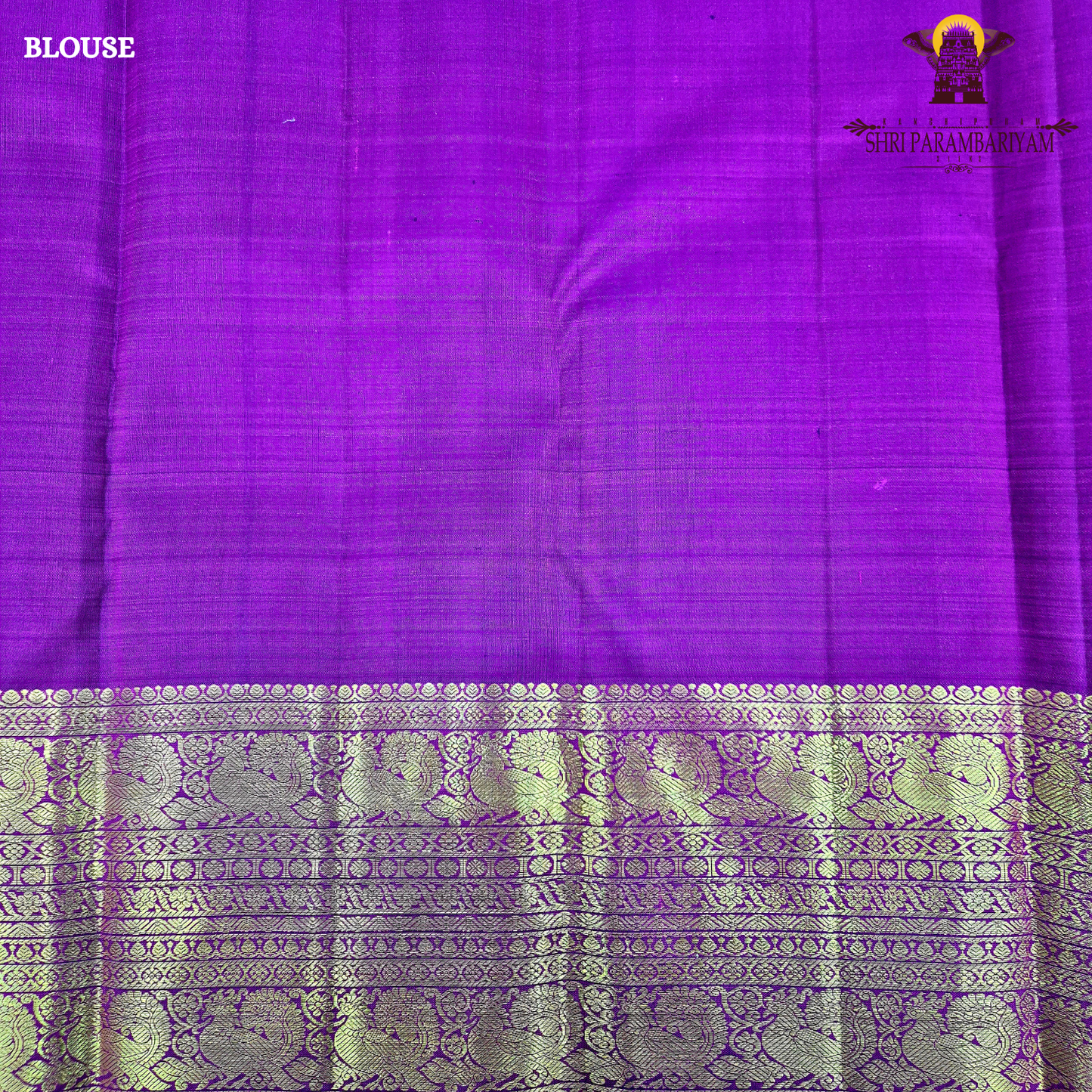 A bright vermilion red with a rich violet/purple border Saree