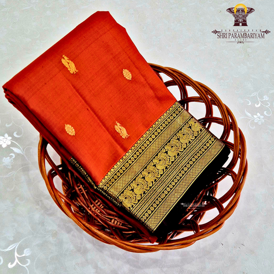 A rich rust orange / deep vermilion shade with a subtle silk sheen Saree