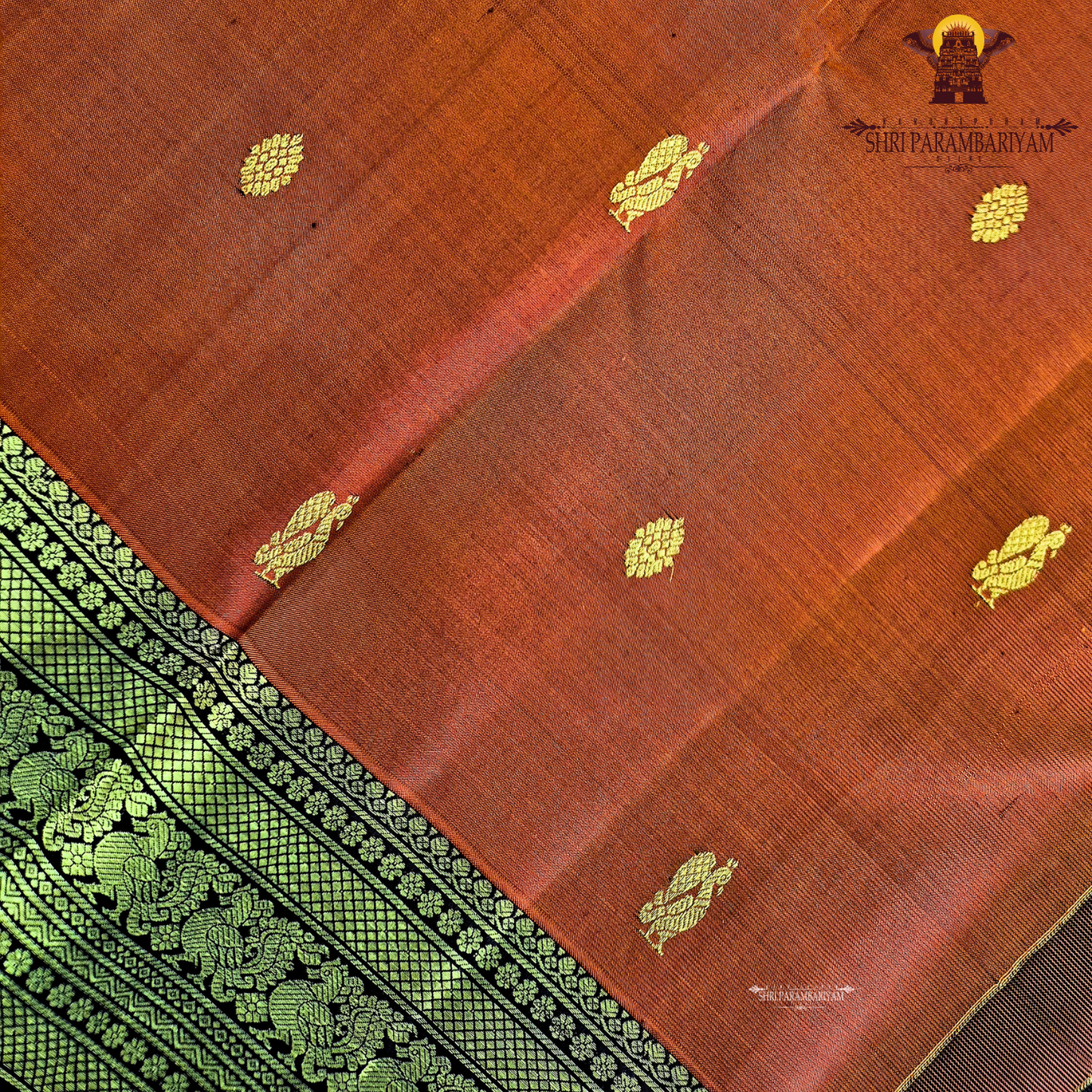 A rich rust orange / deep vermilion shade with a subtle silk sheen Saree