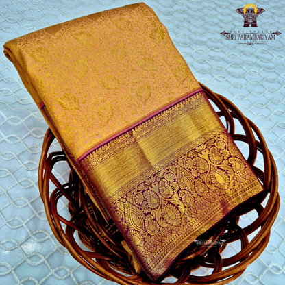 A golden mustard with rich gold zari weaving, complemented by a deep maroon (wine) korvai border Saree