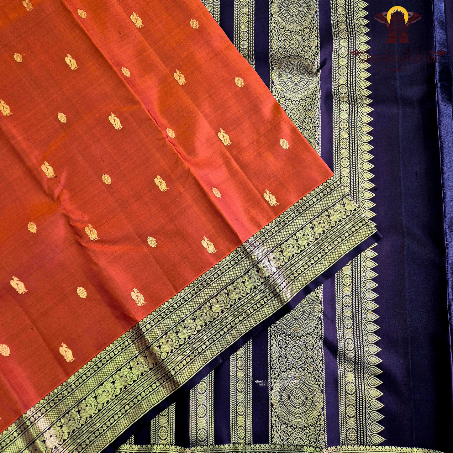 A rich rust orange / deep vermilion shade with a subtle silk sheen Saree