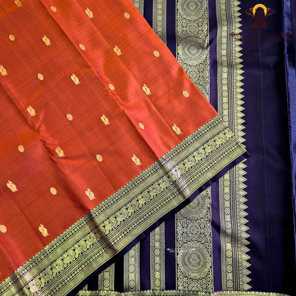 A rich rust orange / deep vermilion shade with a subtle silk sheen Saree
