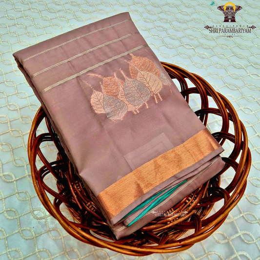 Dusty rose / muted pink shade with a soft metallic sheen Saree