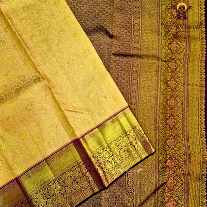 A golden mustard with rich gold zari weaving, complemented by a deep maroon (wine) korvai border Saree