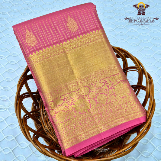 A vibrant bubblegum pink / rose pink body paired with a rich golden zari pallu and border Saree