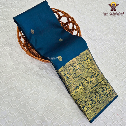 A stunning royal teal blue body adorned with delicate gold zari Saree