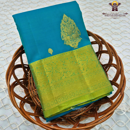 Elegant teal blue (peacock blue tone) with a rich contrast of gold zari and parrot green border Saree