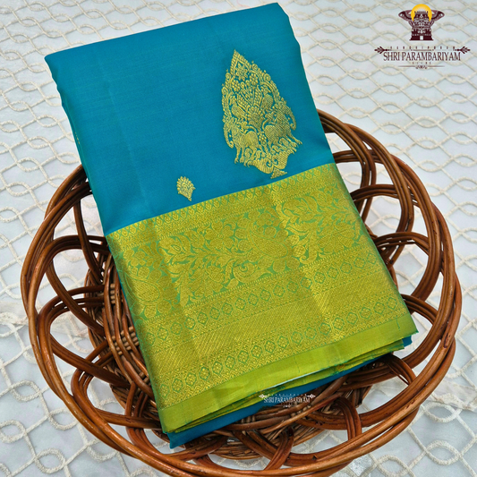 Elegant teal blue (peacock blue tone) with a rich contrast of gold zari and parrot green border Saree