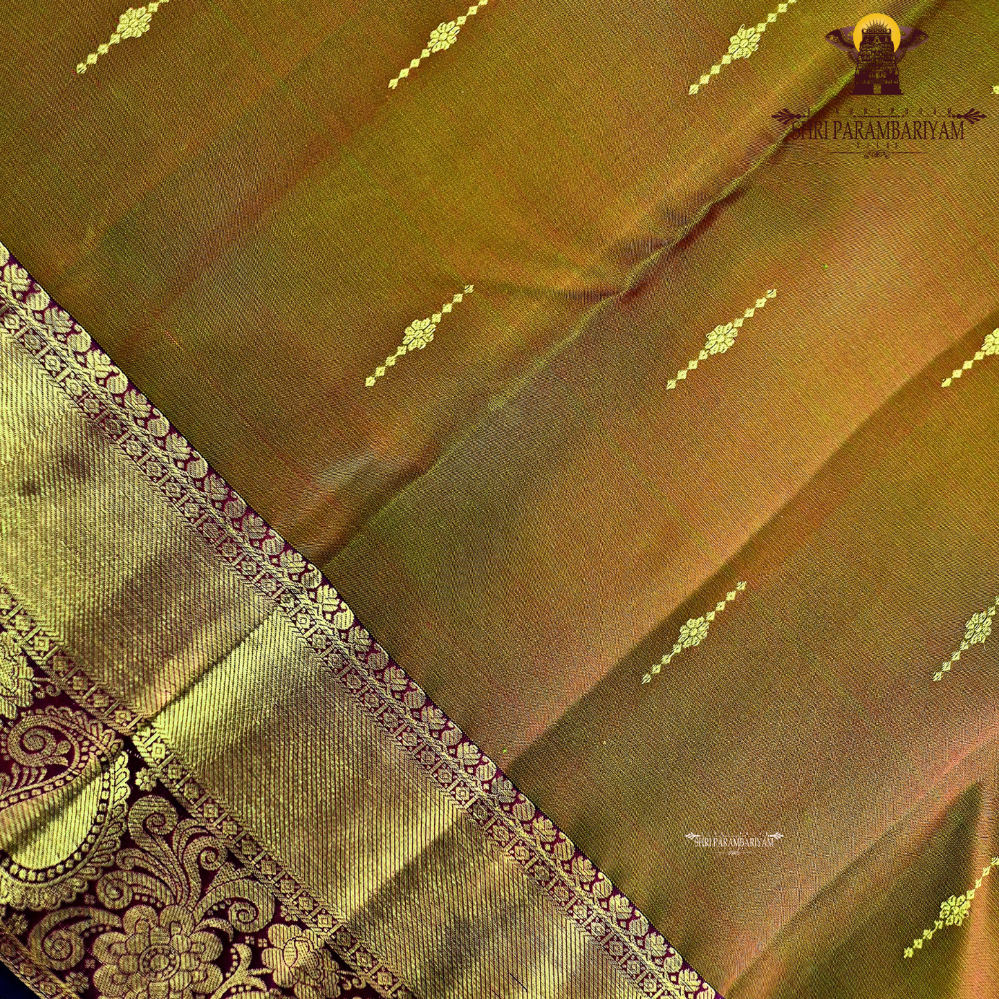 A rich antique mustard / golden olive shade with a warm undertone Saree
