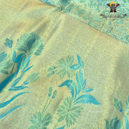 A soothing pastel pista green with a soft gold tissue sheen Saree