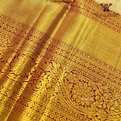 A elegant pastel silver-grey / ivory body paired with a rich antique gold border Saree