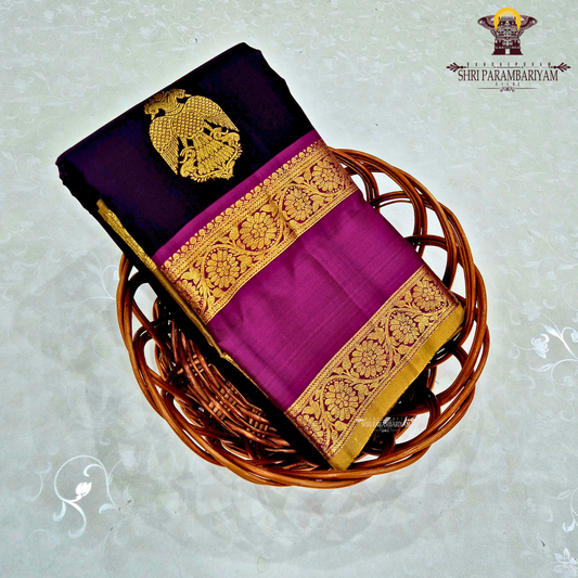 A rich deep violet / royal purple body paired with contrast magenta (pink) and antique gold tones Saree