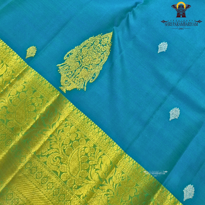 Elegant teal blue (peacock blue tone) with a rich contrast of gold zari and parrot green border Saree
