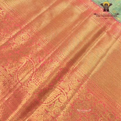 Refreshing pastel green (mint green) body paired with a rich golden-orange Saree