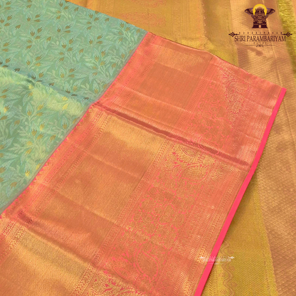 Refreshing pastel green (mint green) body paired with a rich golden-orange Saree