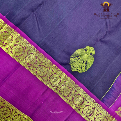 A rich deep violet / royal purple body paired with contrast magenta (pink) and antique gold tones Saree
