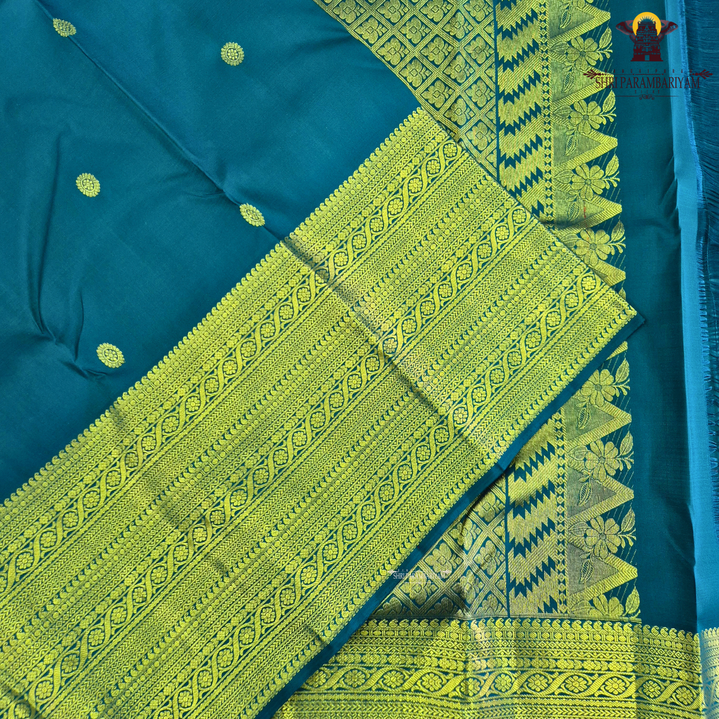 A stunning royal teal blue body adorned with delicate gold zari Saree