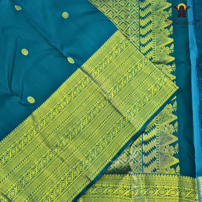 A stunning royal teal blue body adorned with delicate gold zari Saree