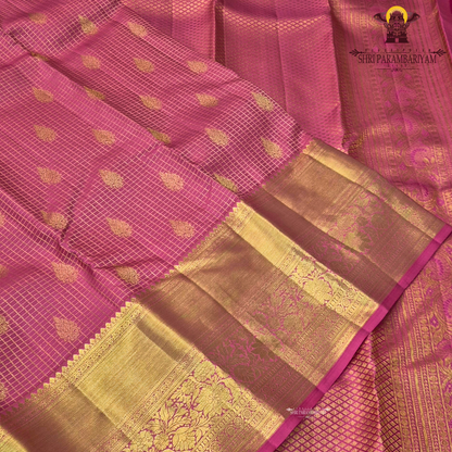 A vibrant bubblegum pink / rose pink body paired with a rich golden zari pallu and border Saree
