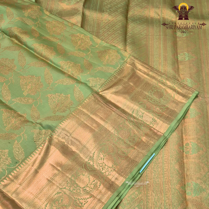 Pastel leaf green with rich gold zari and subtle meenakari accents Saree