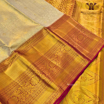 A elegant pastel silver-grey / ivory body paired with a rich antique gold border Saree