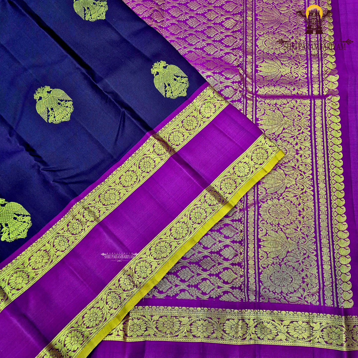 A rich deep violet / royal purple body paired with contrast magenta (pink) and antique gold tones Saree