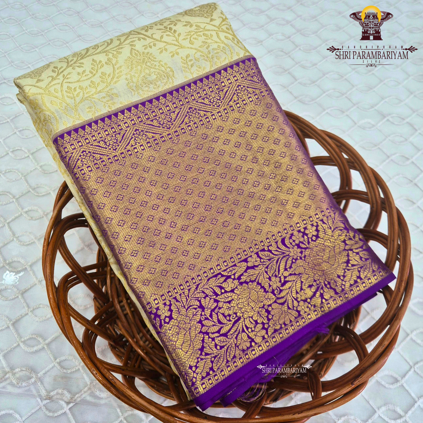 A rich cream/ivory base with a contrasting royal purple border Saree