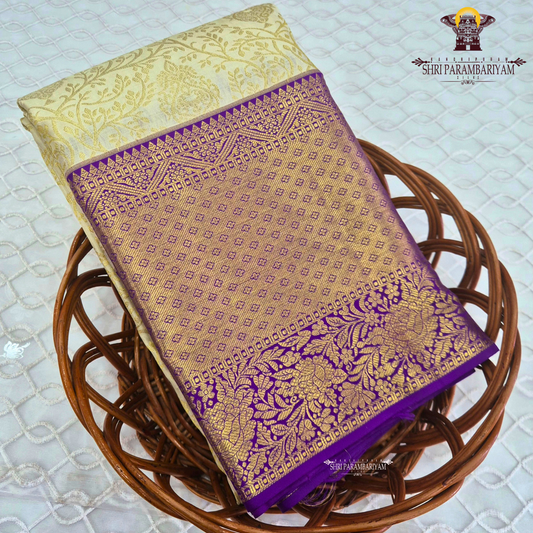 A rich cream/ivory base with a contrasting royal purple border Saree