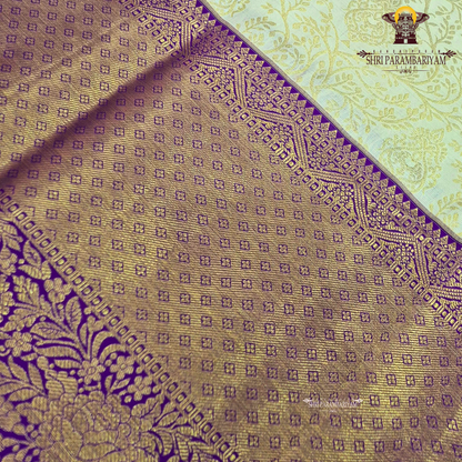 A rich cream/ivory base with a contrasting royal purple border Saree