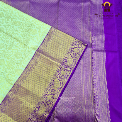 A rich cream/ivory base with a contrasting royal purple border Saree