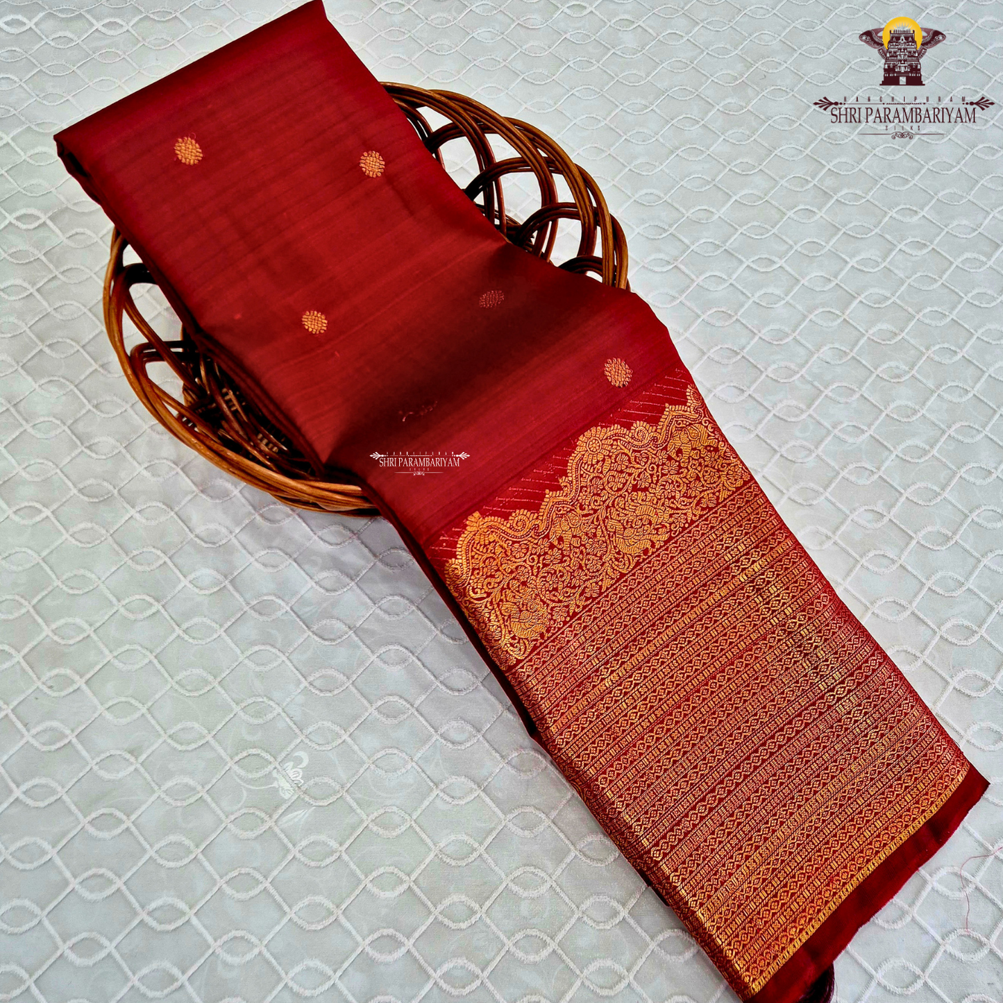 A vibrant ruby red body enhanced with delicate gold zari buttas Saree