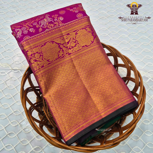 A rich magenta pink body with a contrasting dark green border Saree