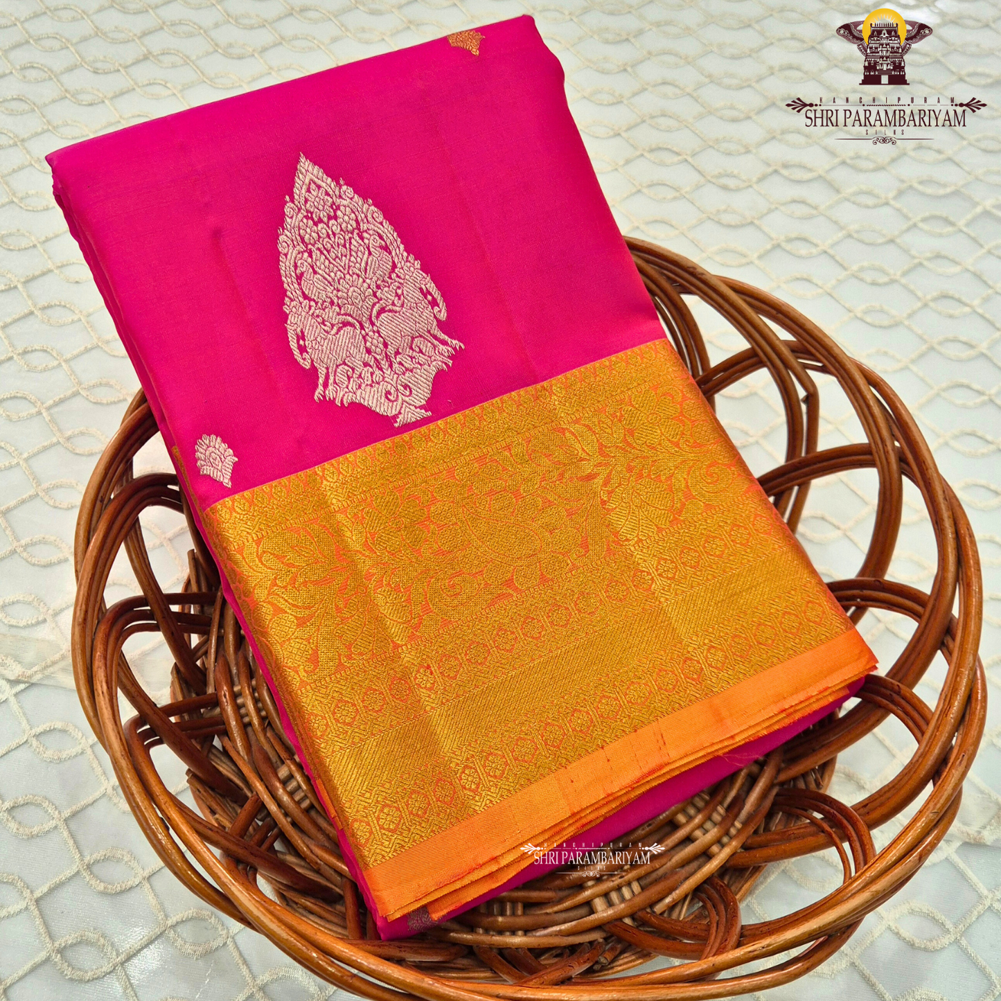 Bright rani pink (vibrant magenta tone) with a rich gold zari border and orange edging Saree